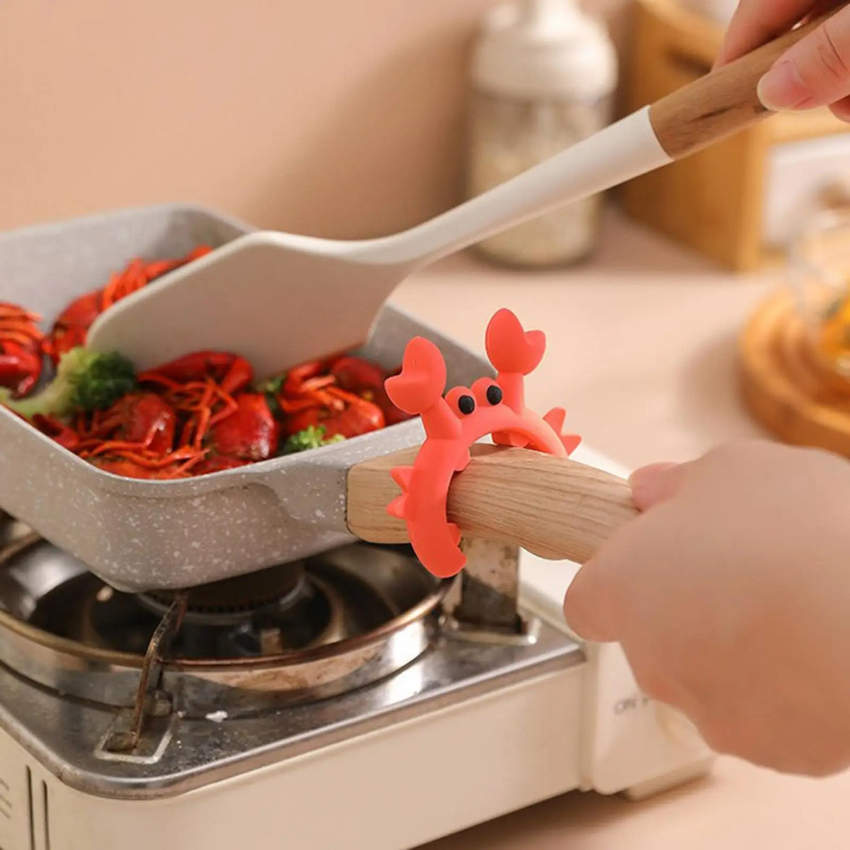 Crab utensil rest propping pot lid